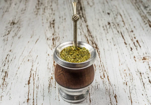 Traditional Argentinian yerba mate tea in a calabash gourd with bombilla stick.