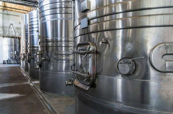 Steel wine tanks for wine fermentation at a winery.