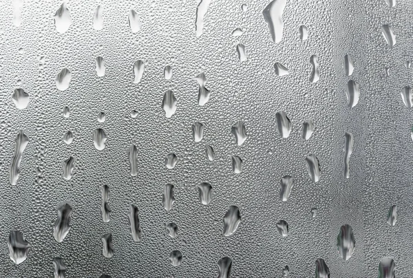 Macro photography water drops on glass window white background after the rain. — Stock Photo, Image