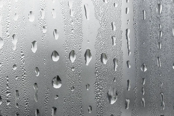 Macro photography water drops on glass window white background after the rain. — Stock Photo, Image