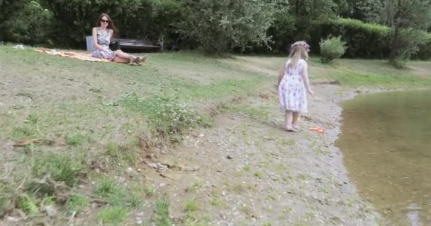 Fille enfant sur le rivage d'un étang — Video