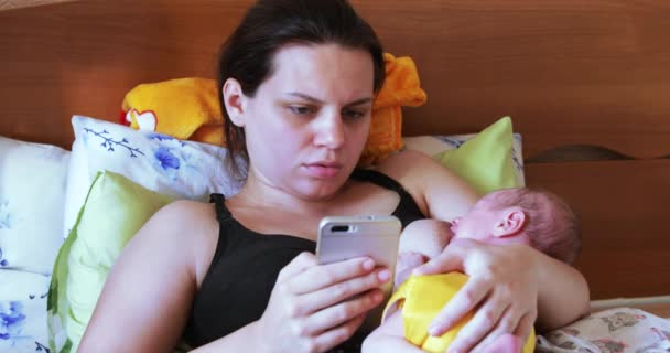 Mama care alăptează cu smartphone — Videoclip de stoc