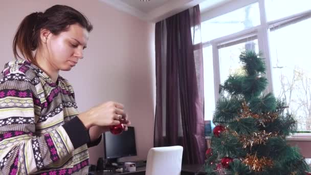 Meisje versiert de kerstboom — Stockvideo