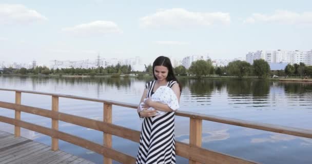 Chica con un niño en un puente de madera — Vídeos de Stock