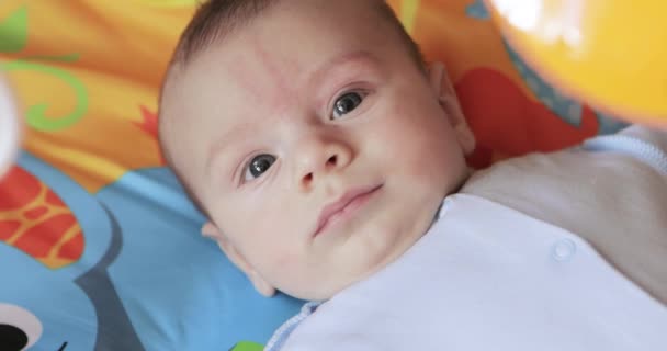 Lying on the bed sheet baby — Stock Video