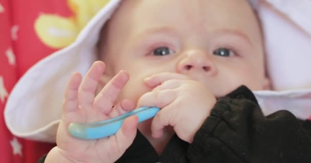 Baby boy holding a spoon — Stock Video