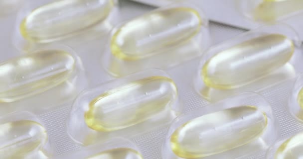 Fish oil in capsules blisters — Stock Video