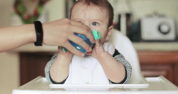 Bebé niño beber agua en una mesa — Vídeo de stock