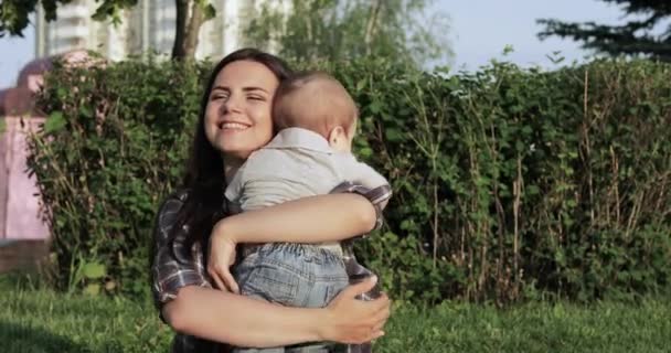 Mamá con el bebé en el césped — Vídeo de stock