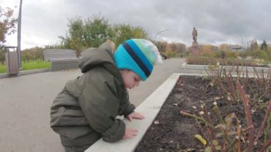 Infant boy delves into ground