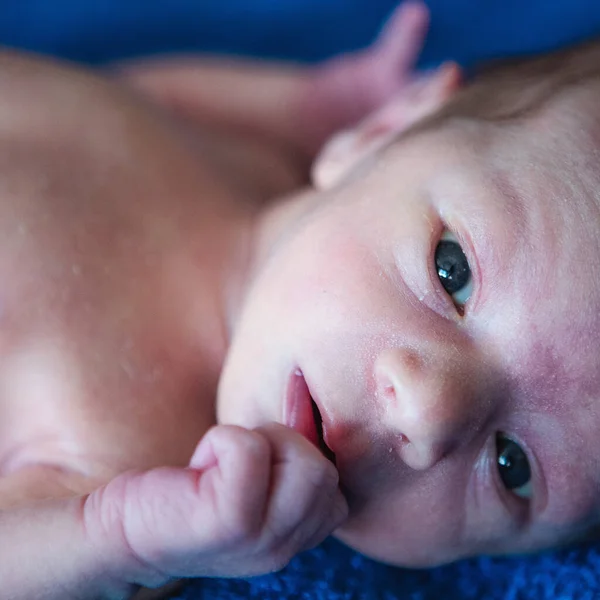 Lying on the bed sheet baby at home — 图库照片