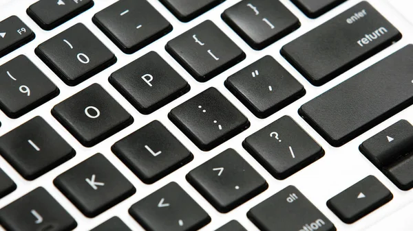 Laptop bilgisayar klavye tuşları, siyah beyaz.