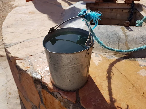 Bucket of water on well