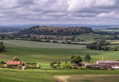 View towards Cadbury Castle - Bronze and Iron Age Hillfort in Somerset in England clipart