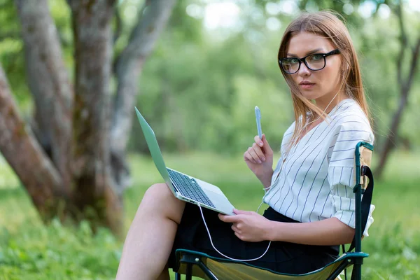Молодая Женщина Ноутбуком Сидящая Парке Складном Стуле Держащая Ручку Руке — стоковое фото
