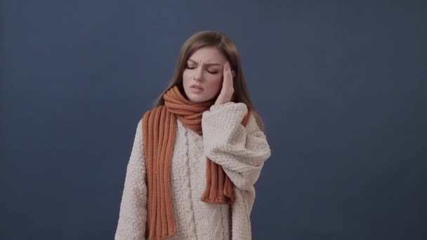 Sick girl wrapped in a warm scarf suffering from nose and headache — Stock Video