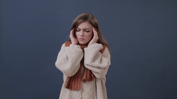 Sick girl wrapped in a warm scarf suffering from nose and headache — Stock Video