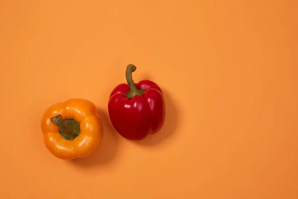 Colorful fruit pattern or background. Two peppers placed on colorful background