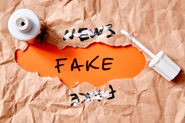 Fake news, disinformation or false information and propaganda concept. Crumpled paper,inscription and corrector
