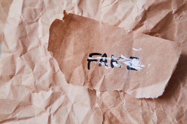 Junk mail or spam and fake letter idea. Concept for unsolicited mail or e-mail. The word fake on a piece of paper.