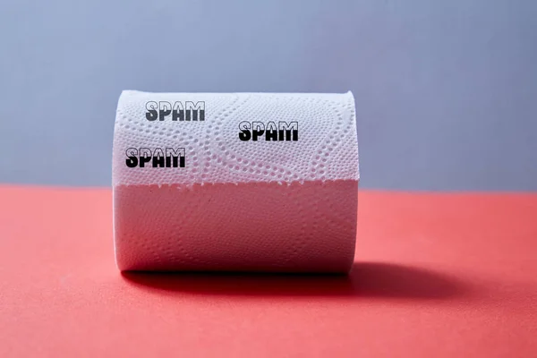 Junk mail or spam e-mail and unsolicited letter idea. Toilet paper with the inscription spam