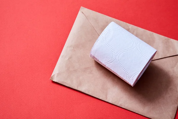 Junk mail or spam e-mail and unsolicited letter idea. A roll of toilet paper and envelope