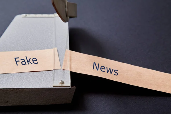 Fake news, disinformation or false information and propaganda concept. Cutter and Kraft paper