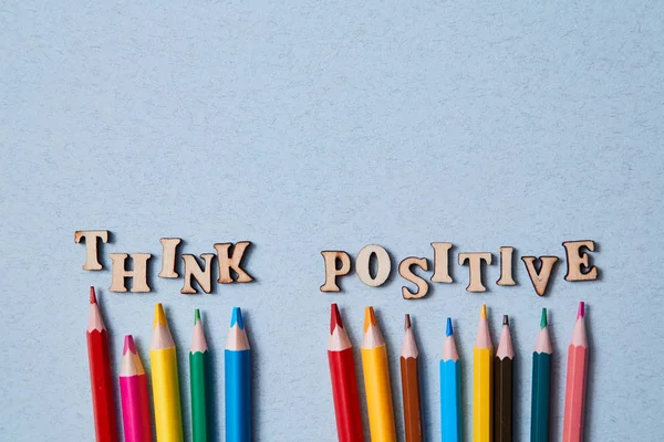 Positive thinking, Happy and optimistic attitude Concept. Colored pencils and the words think positive. Copy space.