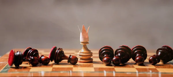 国王或老板，领导和业务战略。棋盘游戏。在丢失件的中间有皇冠的棋子 — 图库照片