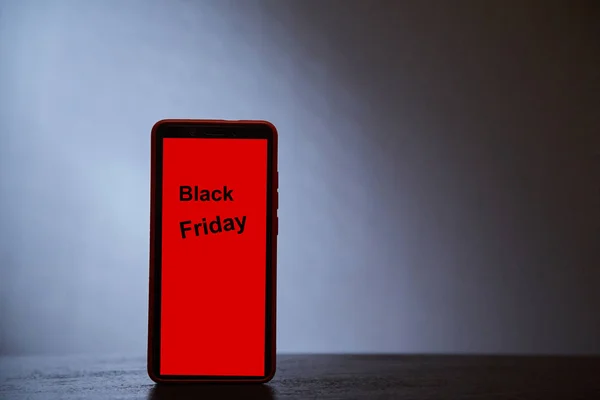 Sale, shopping, discount and e-commerce concept. Black friday. Silhouette of the phone on a gray background — Stock Photo, Image