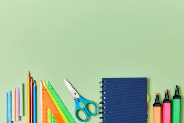 Back to school background. School supplies set. Time to study. Colored crayons and pencils, ruler, notepads and markers