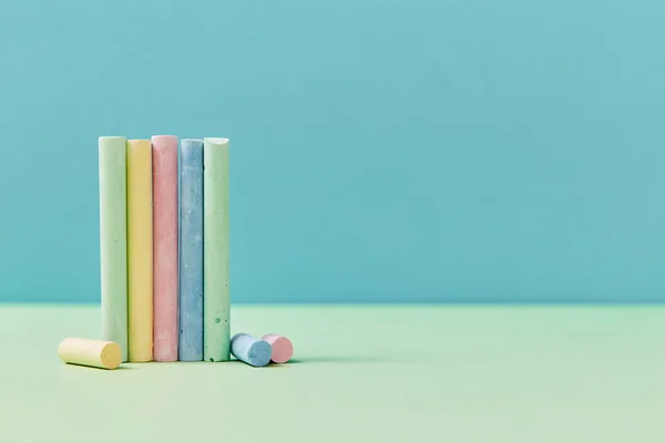 Okul malzemeleri. Okula başla. Okul konseptine geri dönelim. Ders çalışma zamanı. Mavi arkaplanda renkli boya kalemleri, boşluğu kopyala