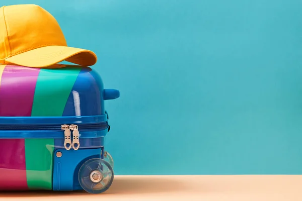 Time to travel. Summer vacation. Travelling abroad. Summer holidays. Colourful suitcase and cap on top, place for text — Stock Photo, Image