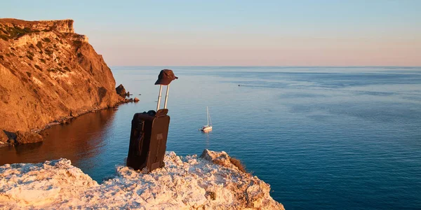 Time to travel or Summer holidays. Travelling concept. Suitcase on rock. Breathtaking seaview and sunset on background — Stock Photo, Image