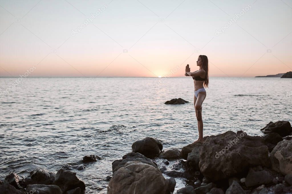 Lady balancing on one leg. Woman training outdoors on fresh air. Contemplation and relaxation. Yoga time, copy space
