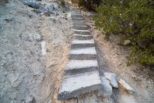 Concrete cement staircase on nature. Lack of roads and steep rise in desert area. Adventure and active lifestyle idea — Stock Image Concrete cement staircase on nature. Lack of roads and steep rise in desert area. Adventure and active lifestyle idea Royalty Free Stock Images