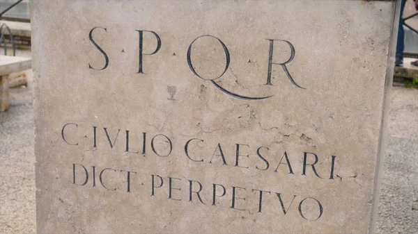 Roman writing and bas-reliefs imperial era archeology italy. Stock. SPQR inscription on the wall