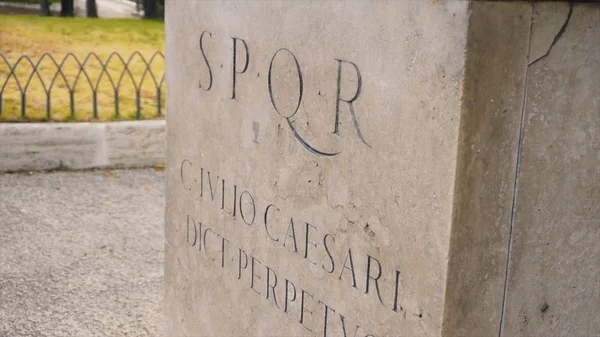 Roman writing and bas-reliefs imperial era archeology italy. Stock. SPQR inscription on the wall