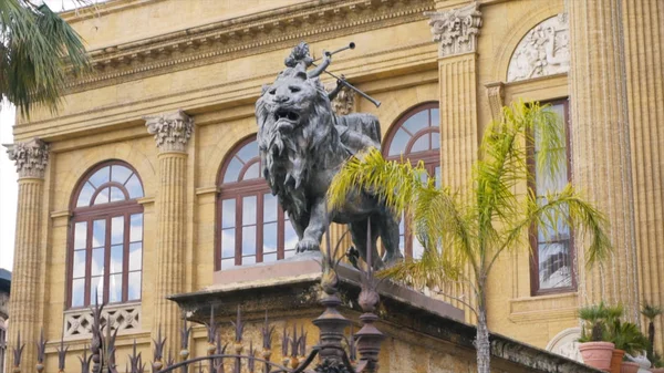 Lion statue in front of the Theater Massimo Vittorio Emanuele in Palermo, Sicily, Italy. Stock. Lion statue in Italy