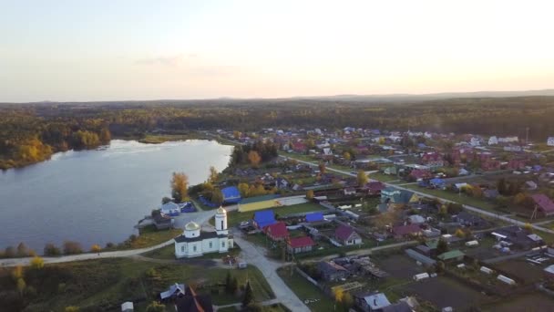 Vue de dessus de la petite localité près d'un lac. Vidéo. Vue du dessus du village près de la forêt et du lac 