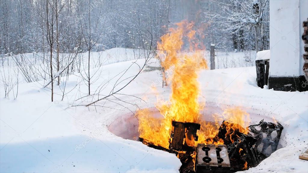 Burning things in nature in winter. Clip. Controlled fire in the forest in winter