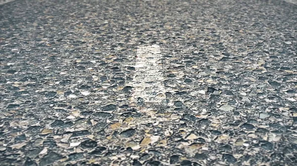 Close-up texture of an asphalt road with marking. White line on asphalt road close up. soft focus. Asphalt road with marking lines and tire tracks. Close up photo with selective focus — Stock Photo, Image