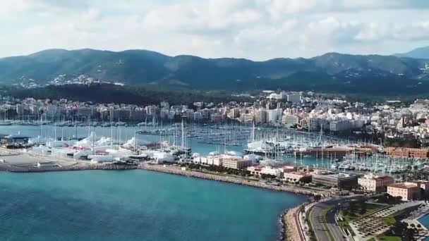Aerial view of beautiful mountains and island on the background, a lot of yacht and sailboat. Stock. Colorful landscape with boats in marina bay, sea, city, mountains. Top view from drone of harbor — Stock Video