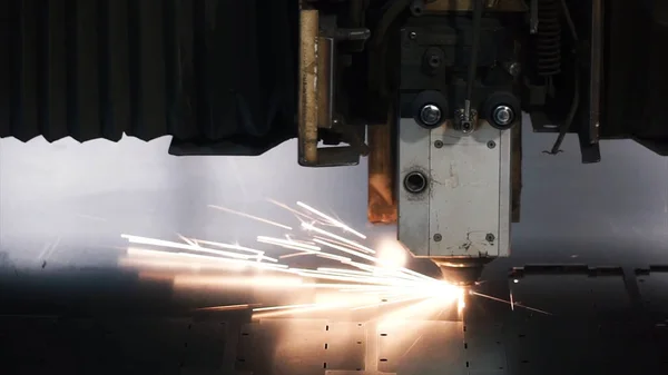 Laser machine cutting of sheet metal. Clip. Sparks fly from laser by automatic cutting CNC, PLC machine