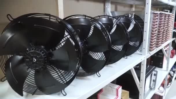 Fans on the shelf. Clip. Many coolers on the shelf — Stock Video