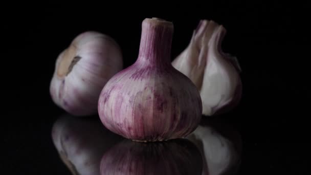 Delicious beautiful garlic on black background. Frame. Concept of a healthy lifestyle — Stock Video