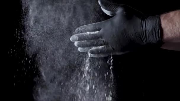 Cotton hands with flour on black background. Frame. Chef clapping hands covered in flour — Stock Video