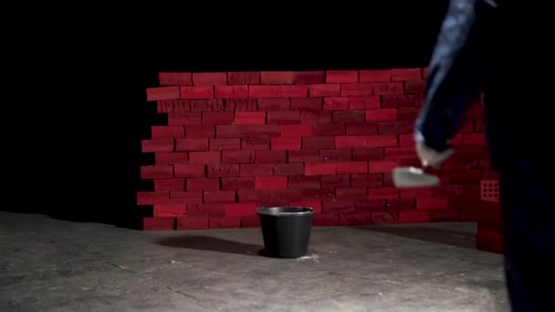 Man working near brick wall. Stock. Concept of self-development. Create yourself — Stock Video