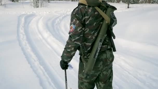 O grupo de soldados corre em esquis na floresta com armas. Clipe. Soldados com fuzis AK-47 e lança-granadas atravessando a floresta de inverno em esquis. Soldados em exercícios na floresta no inverno — Vídeo de Stock