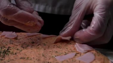 Pişirme pizza ağır çekim. Çerçeve. Peynirli pizza yapımı, domates salçası, sosis ve hardal. Aşçı iş. Aşçı, peynir ve domates salça ile adet sosis ve pizza düzenler. Tam